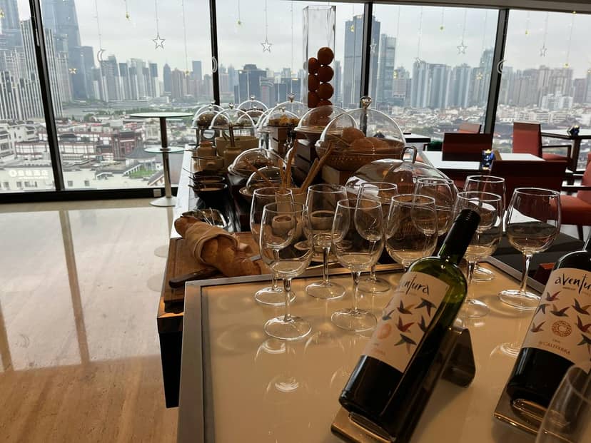 Buffet setup with pastries and city skyline at Renaissance Shanghai Yu Garden Hotel event.