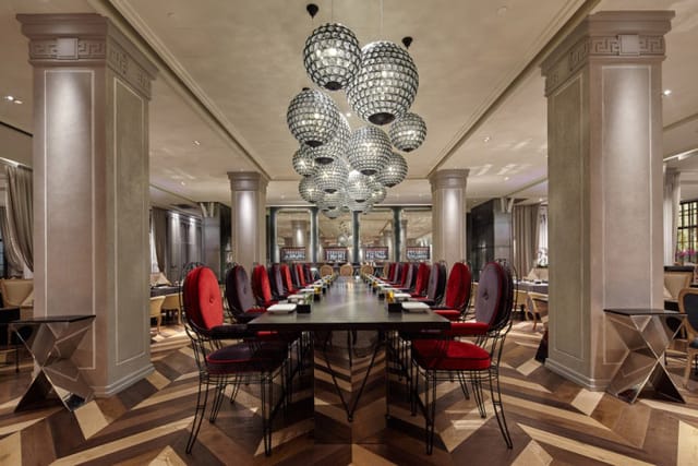 Private dining room with elegant table and red chairs for upscale corporate events.