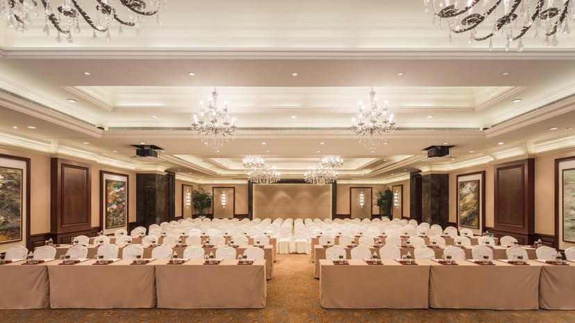 Grand Banquet Hall setup for corporate events with elegant white table covers.