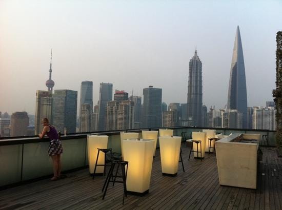 Rooftop lounge at Hotel Indigo Shanghai with skyline view, perfect for upscale events.