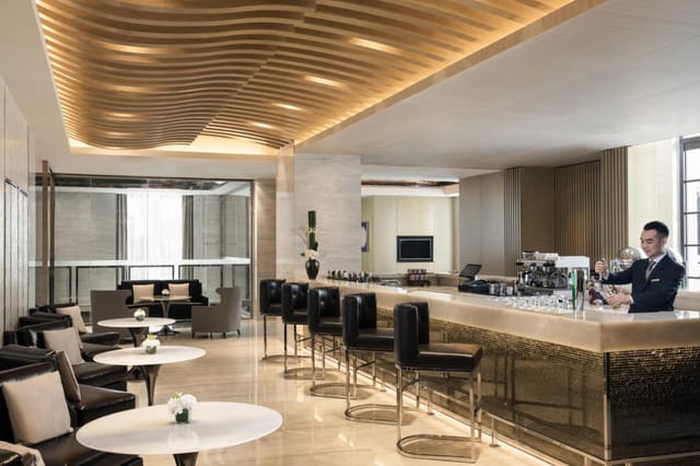Modern bar area in Suites, Courtyard Shanghai for networking events and cocktail receptions.