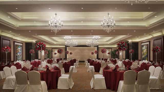 Elegant banquet hall with chandeliers, perfect for weddings and corporate events.