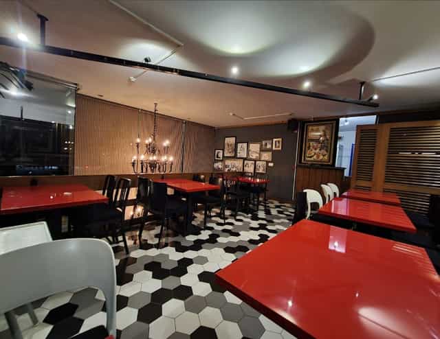 Stylish dining space with red tabletops, ideal for intimate gatherings and corporate events.