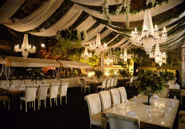 Elegant outdoor event space with chandeliers, ideal for upscale weddings and gatherings.