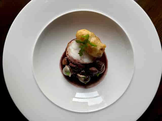 Private dining room at The Royal Oak with gourmet dish for upscale events.