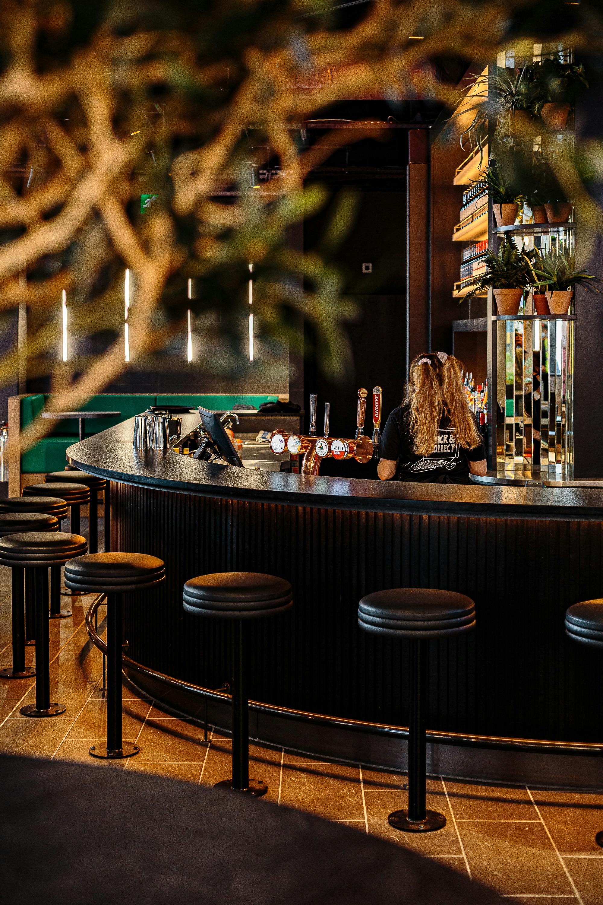 Sleek bar setup at PizzaLuxe Manchester for networking events and social gatherings.