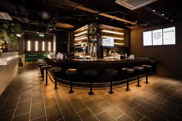 Sleek bar area at PizzaLuxe Manchester for networking events and cocktail receptions.