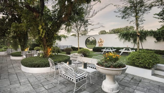 Outdoor event venue at The White Rabbit with lush greenery and elegant decor.