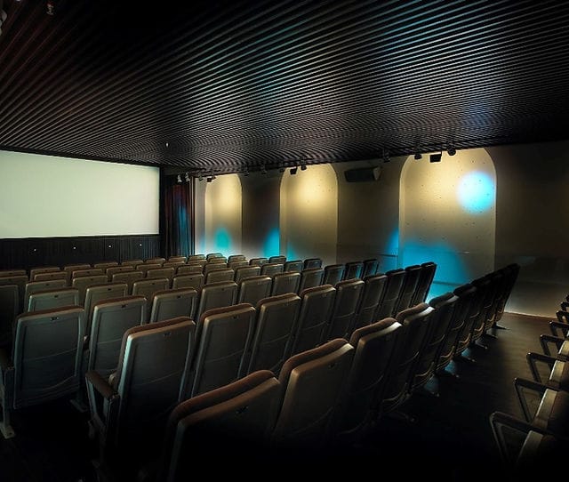 Modern auditorium with tiered seating for corporate events and film screenings.