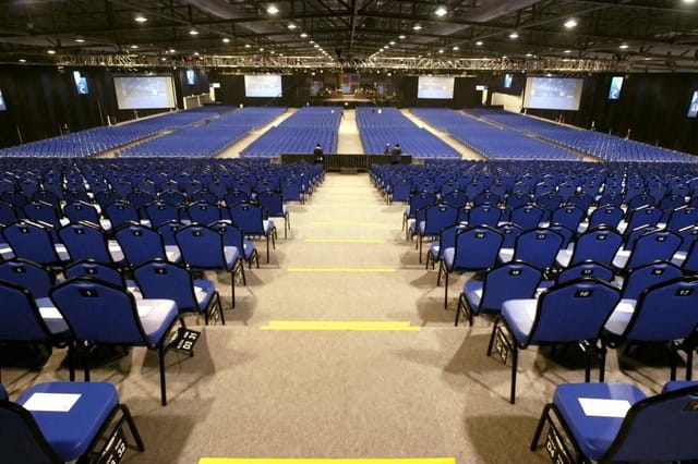 Arena @ EXPO Singapore with blue chairs set for a major event and audience engagement.