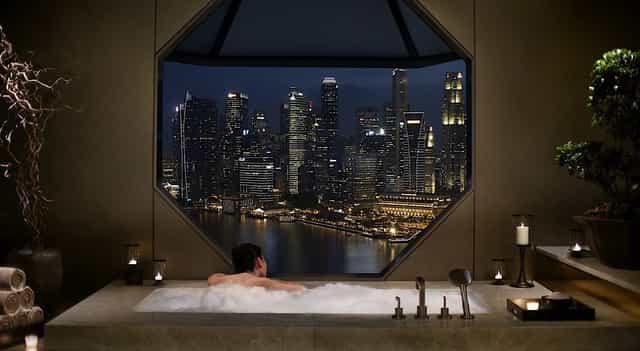 Luxurious Ritz-Carlton suite with city skyline, ideal for corporate retreats and events.