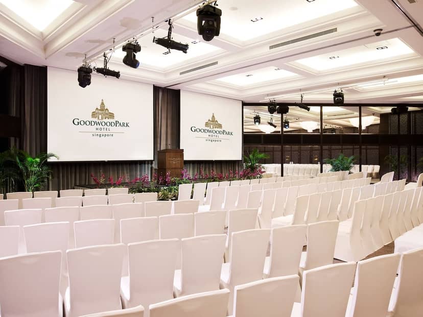 Ballroom at Goodwood Park Hotel with white chairs, ideal for corporate events and conferences.