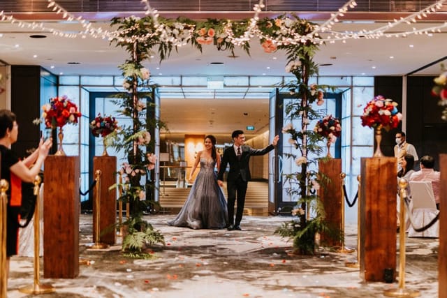 Grand Ballroom wedding entrance with floral decor and soft lighting at Singapore Marriott.