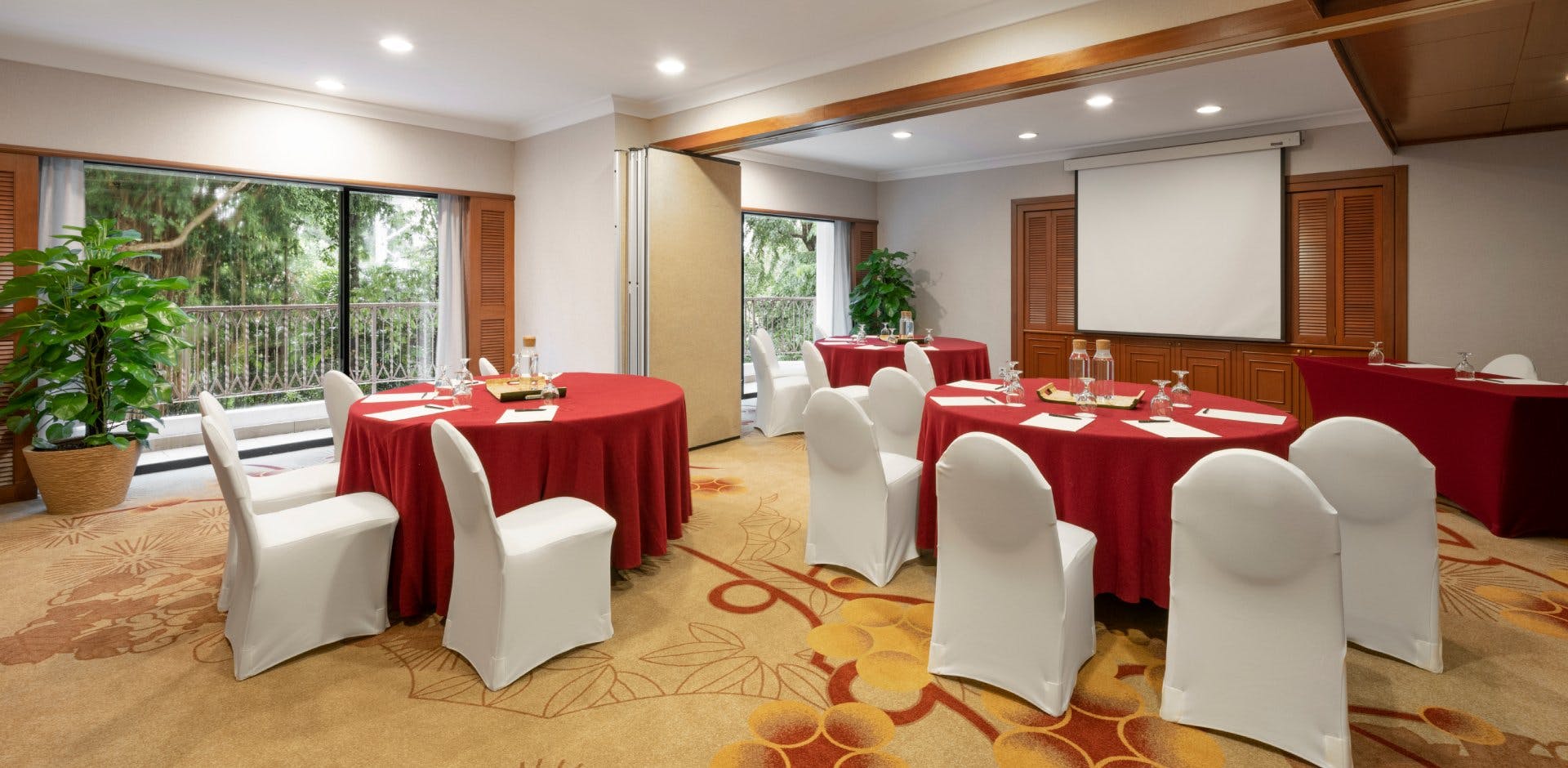 Meeting room in Shangri-La Singapore with round tables, ideal for workshops and seminars.