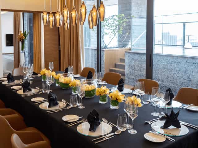Elegant dining table with black linens for upscale corporate event at One Farrer.