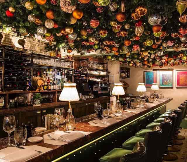 Elegant bar at Daphne's with festive decor, perfect for upscale events and gatherings.