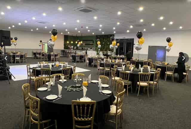 Elegant No.4 Events Hall with black and gold decor for formal gatherings and celebrations.