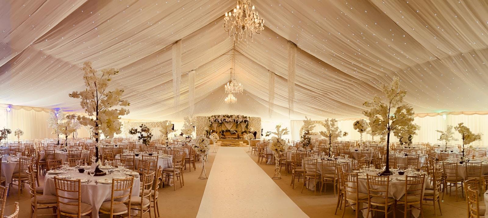 Elegant Grand Marquee tent with twinkling lights, ideal for weddings and upscale events.