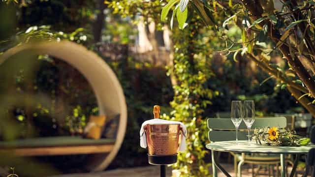 Outdoor event space at Park Plaza Vondelpark with elegant champagne setup and greenery.