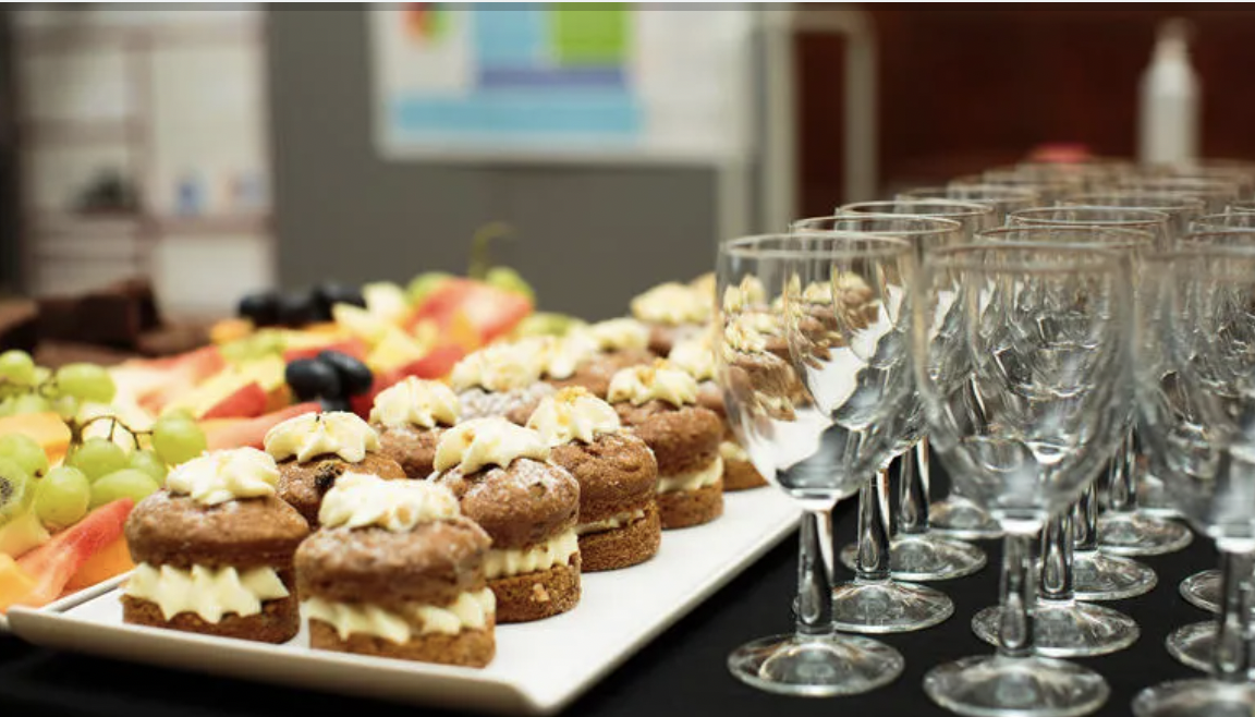 Refreshment table with mini cakes at King's Venues, ideal for elegant events and catering. - Banner