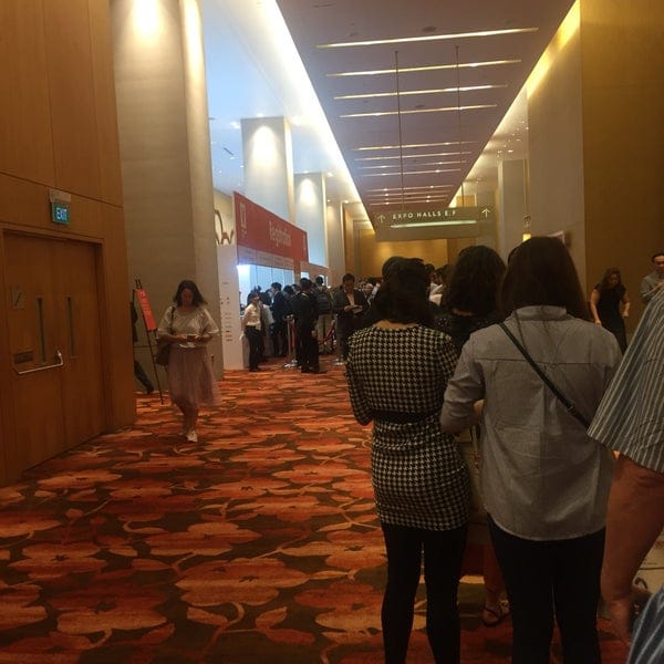 "Busy event registration at Sands Expo, showcasing modern decor and efficient check-in."