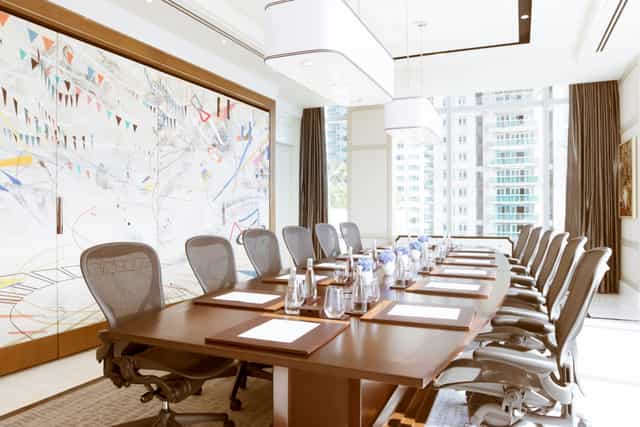 Modern conference room at Raffles Hotels, ideal for meetings and brainstorming sessions.