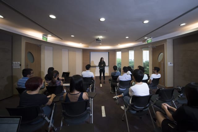 Event Space in *SCAPE with presenter, natural light, ideal for meetings and collaboration.