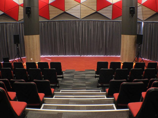 Main Hall in *SCAPE with tiered seating, ideal for presentations and workshops.