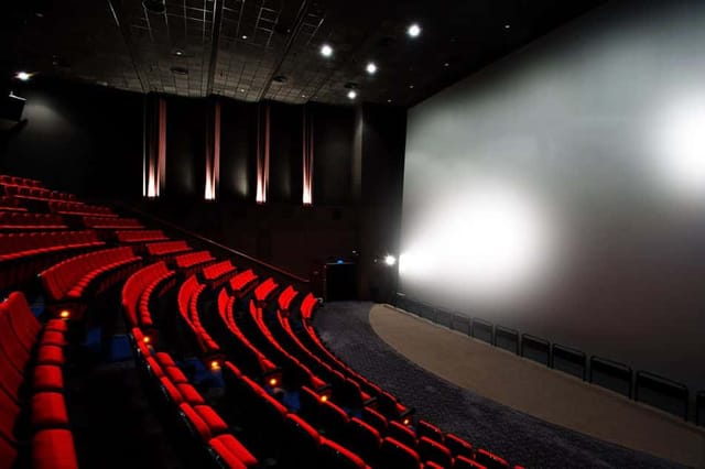iWERKS Theatre in Singapore: modern auditorium with red seating for corporate events.