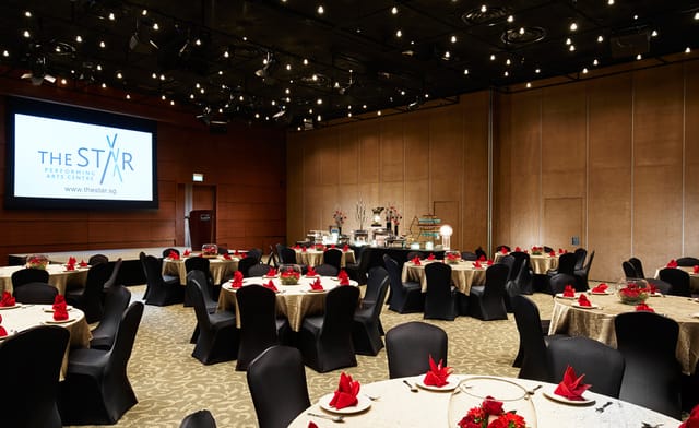 Multi-purpose event hall with elegant tables, ideal for corporate meetings and formal gatherings.