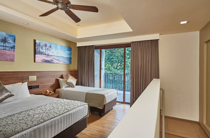 Comfortable hotel suite with twin beds, perfect for events and relaxation.