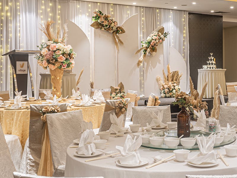 Elegant event space at Village Hotels with white and gold decor, perfect for weddings.