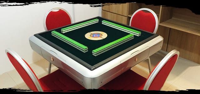 Modern mahjong table with red chairs for engaging events and networking activities.