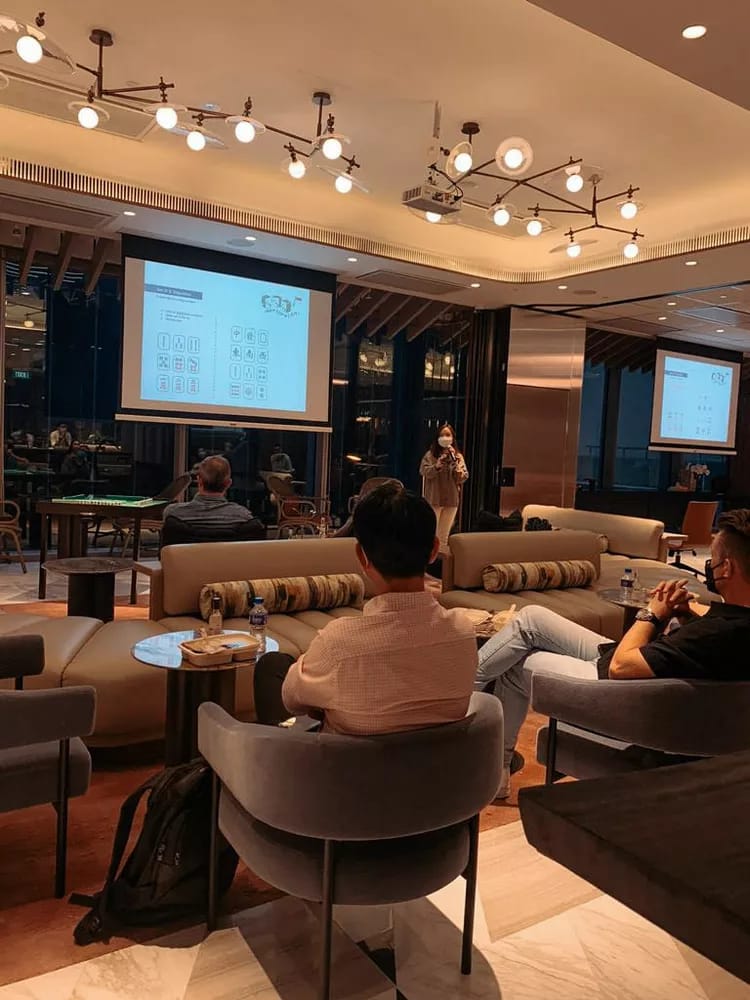 Mahjong Room event with speaker, modern venue, professional networking and collaboration.