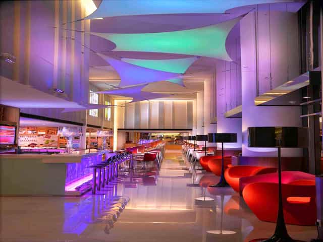 Modern event space at Ibis Singapore with vibrant lighting, ideal for networking and receptions.