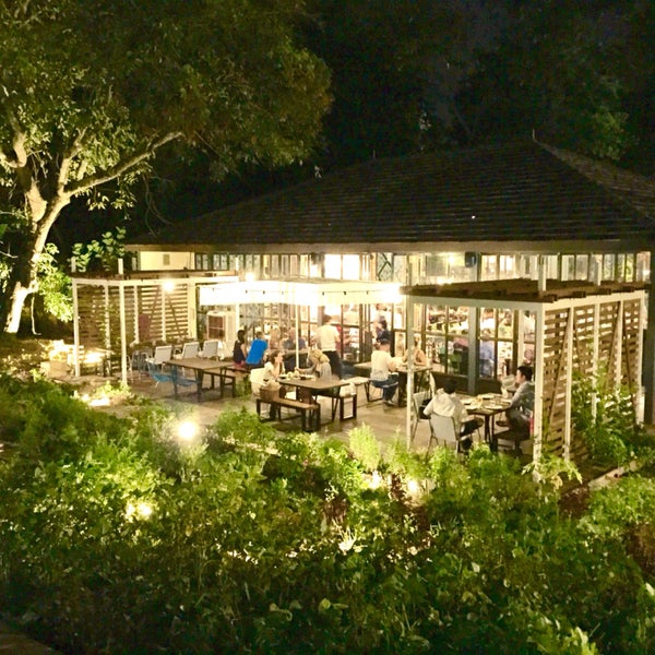 Charming outdoor dining space with lush greenery for events at Open Farm Community.