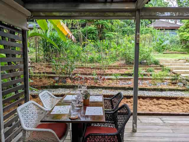 Outdoor dining setup at Brunch restaurant, ideal for networking events in lush greenery.