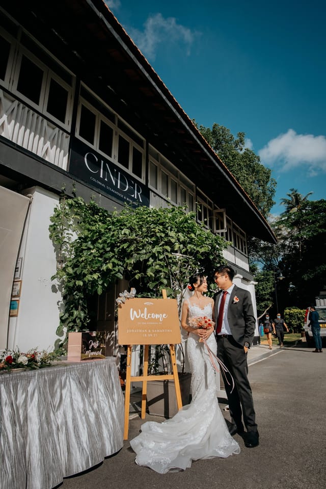 Elegant wedding welcome area at Wheeler's Estate with lush greenery and charming couple.