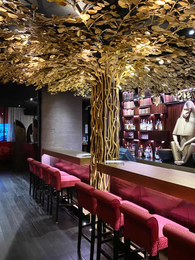 Whiskey Library & Jazz Club bar with tree-like decor, ideal for networking events in Singapore.
