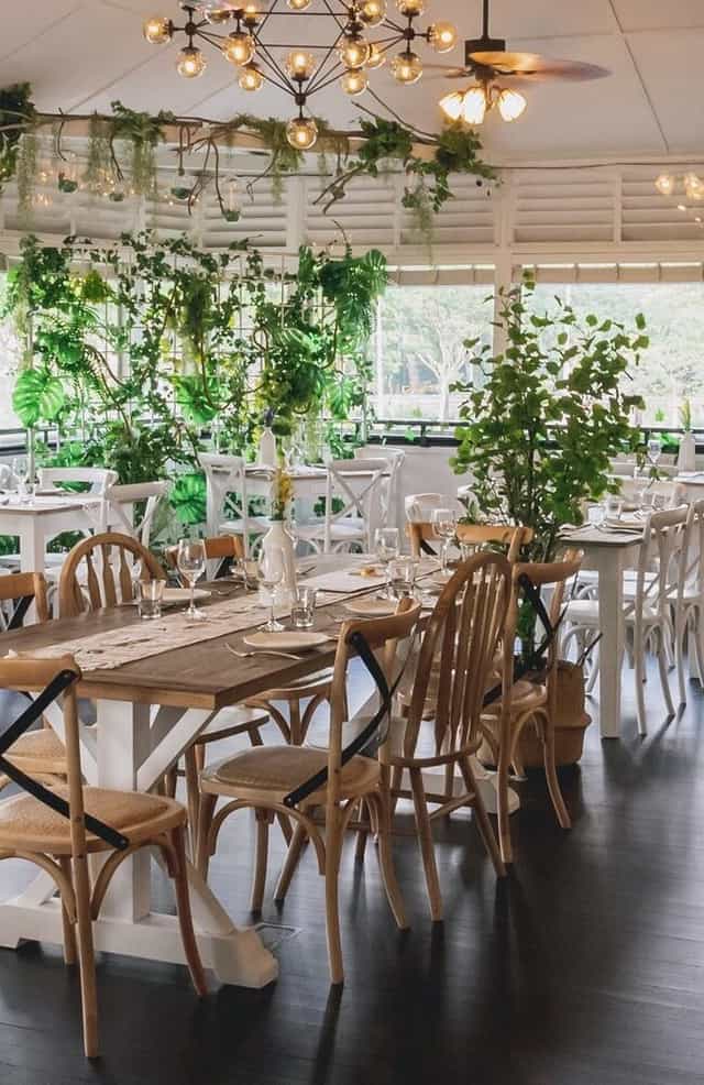Elegant dining hall with greenery, perfect for intimate gatherings and corporate events.