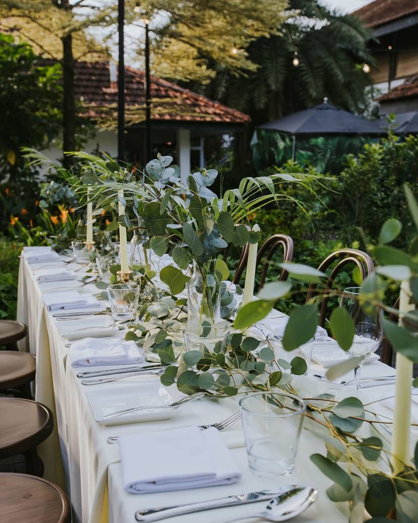 Elegant outdoor dining table with candles at Botanico for upscale events.