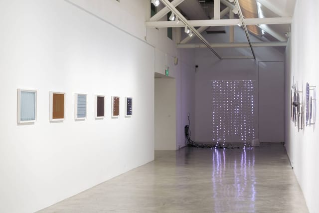 Modern gallery space with framed artworks, ideal for art exhibitions and corporate events.