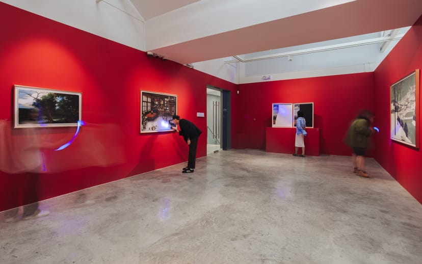 Vibrant red gallery space at STPI for art exhibitions and networking events.
