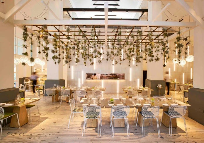Modern event space at COMO Dempsey with stylish seating and elegant lighting for gatherings.