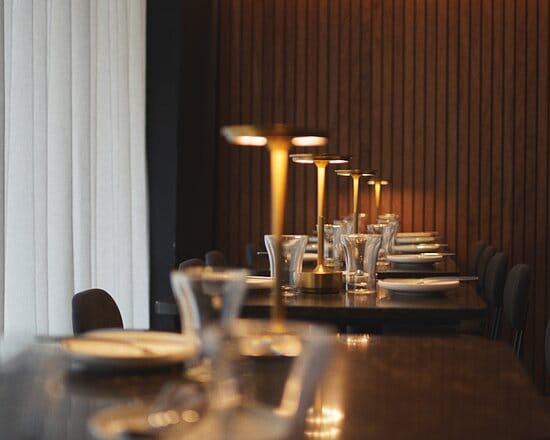Sleek modern dining setup in LUMO Bar Restaurant for intimate events and meetings.