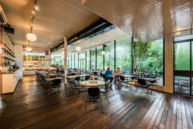 Modern PS.Cafe venue with large windows, perfect for meetings and events.
