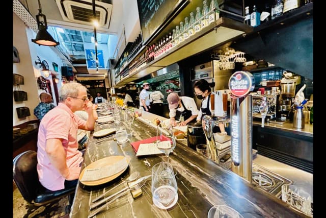 Vibrant Esquina restaurant with sleek bar, ideal for intimate gatherings and private dining.