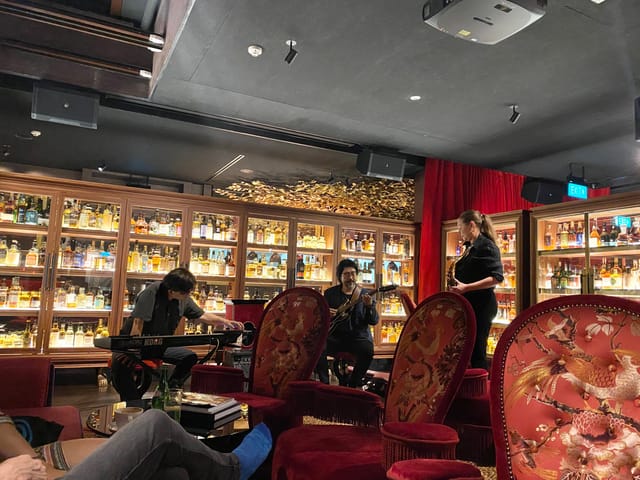 Whisky Library lounge with shelves of spirits, ideal for networking events and private gatherings.