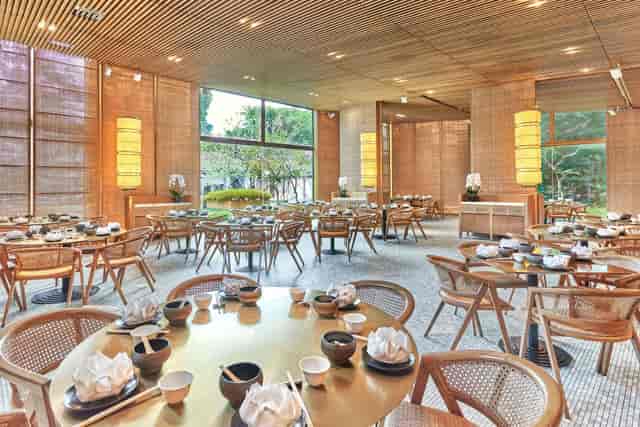 Elegant dining hall in Min Jiang, featuring round tables for upscale events and gatherings.