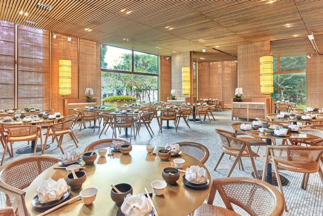 Elegant dining hall in Min Jiang, featuring round tables for upscale events and gatherings.